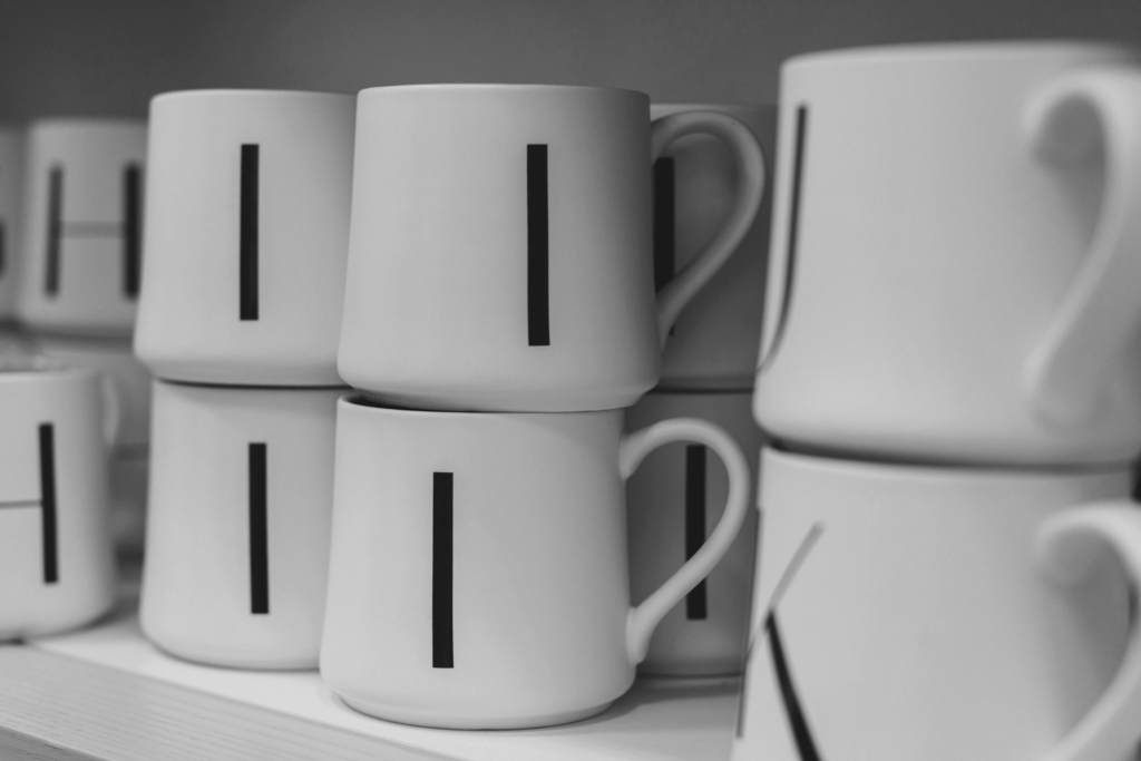 A shelf of mugs featuring initials